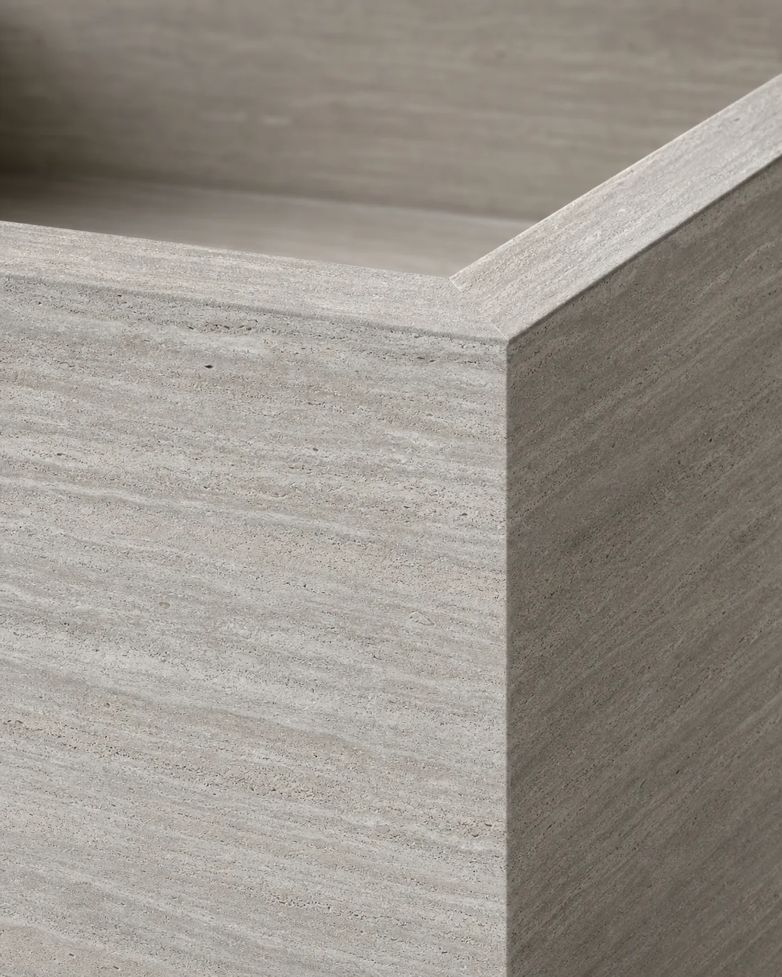 Close detail of a mitred silver-travertine porcelain edge