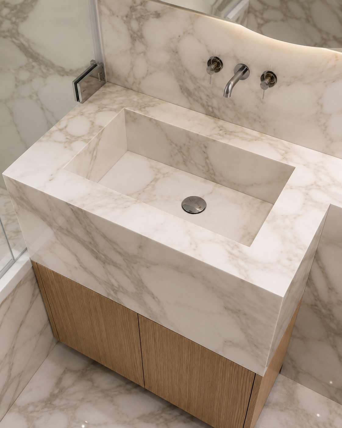 Completed made-to-measure Arabescato-effect porcelain bathroom basin integrated with warm oak vanity storage