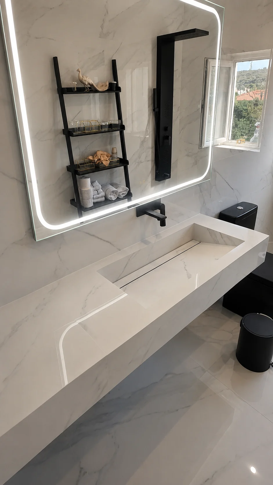 Floating Porcelain with a Calacatta pattern sink with illuminated mirror and black tap mounted on the wall