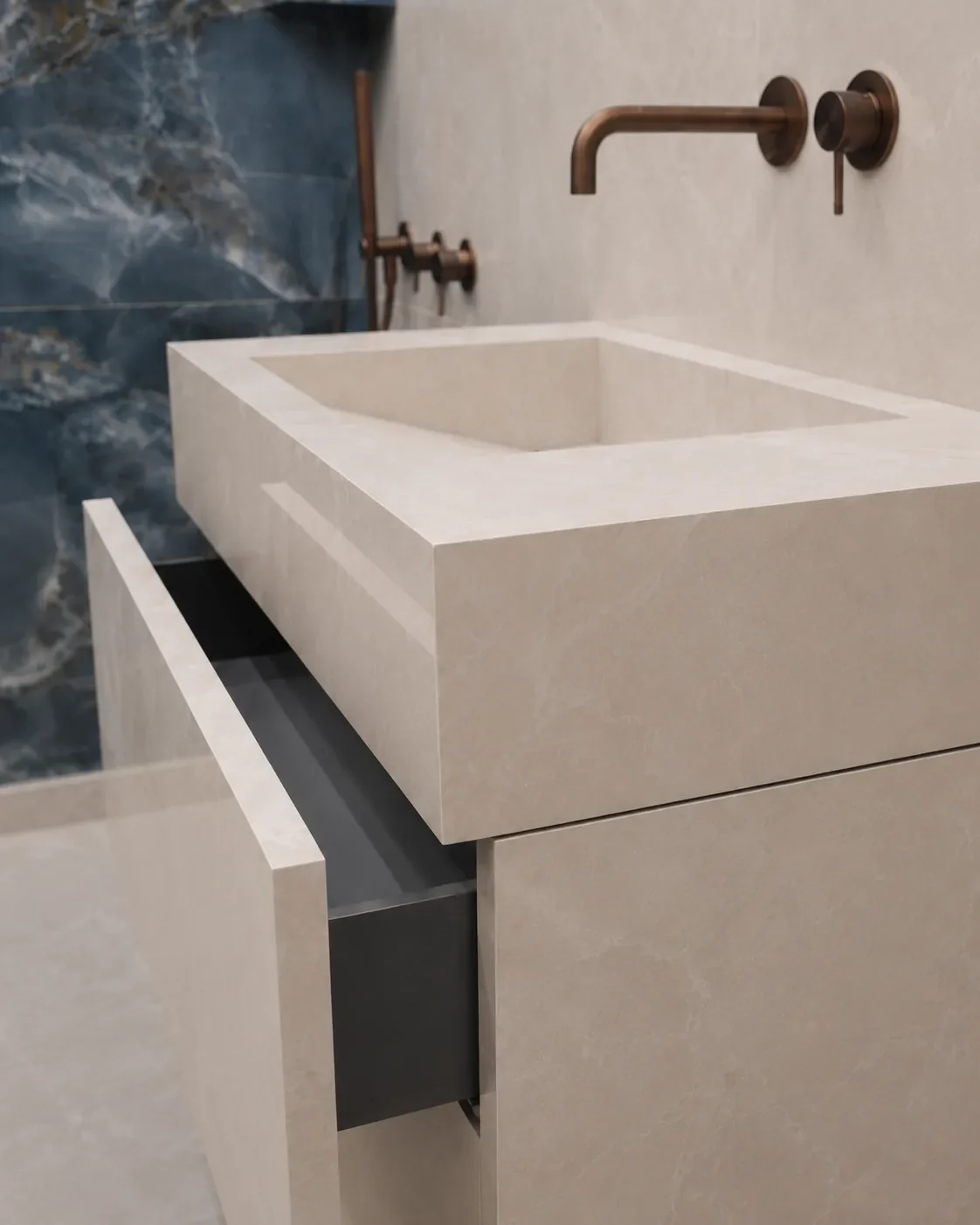 Beige porcelain bathroom vanity with a marble pattern, mitred sink and aligned drawer joints.