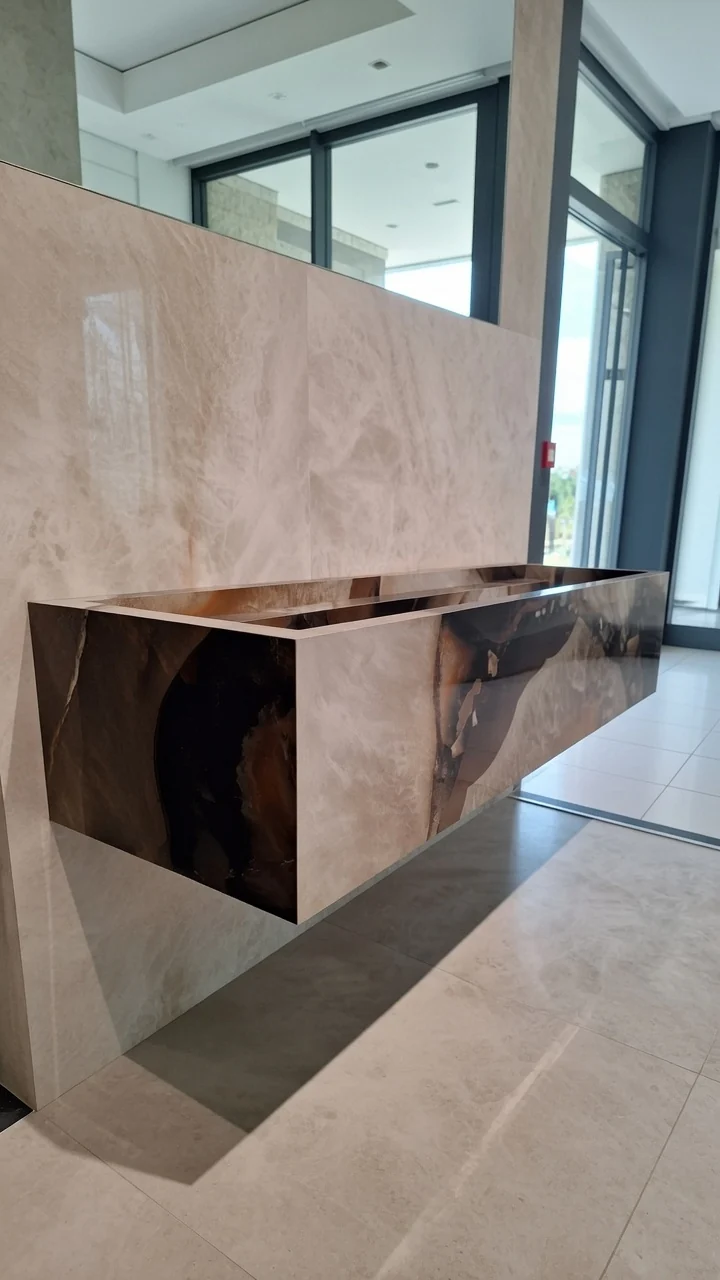 Statement floating porcelain sink with onyx pattern veining and integrated basin